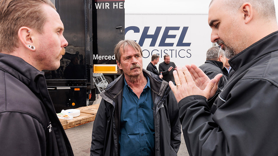 Il dipendente Daimler Steffen Maier (dx) mentre discute con il responsabile del parco veicoli Alfred Böpple (al centro) e il conducente Daniel Radtke.