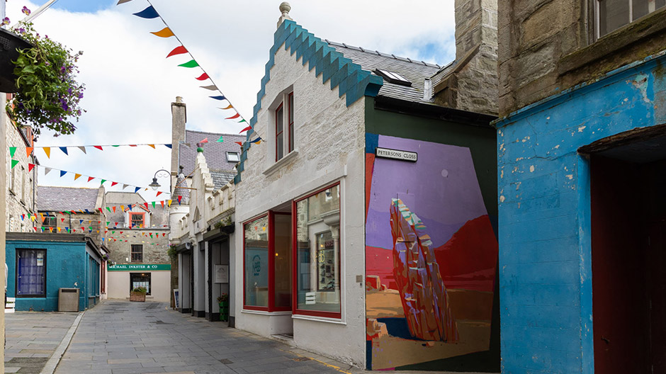 Brick building in Lerwick, colourful street art, and many abandoned settlements.